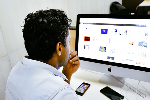 member working in open work space on personal monitor