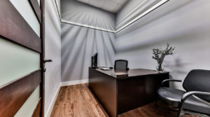 private office for monthly membership fee that has two chairs and a desk with access to open coworking space and ethernet port