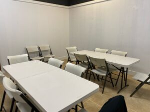 multi-functional classroom event space with various tables and chairs for hourly rental fee