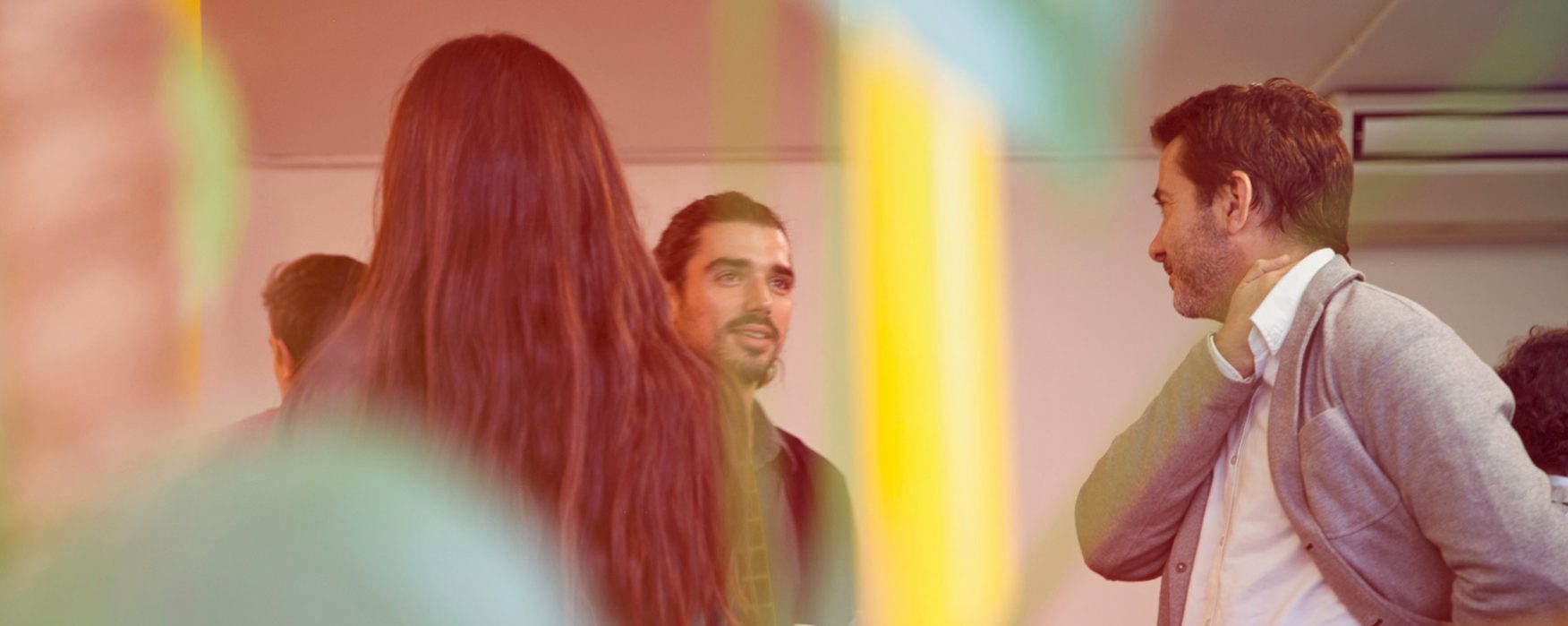 a glmipse of coworkers through a plant